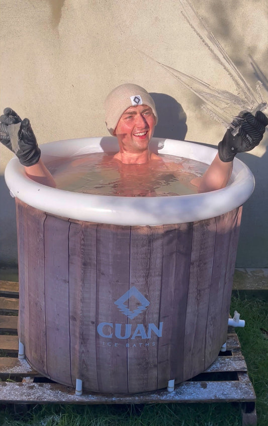 man in ice bath holding icicle 