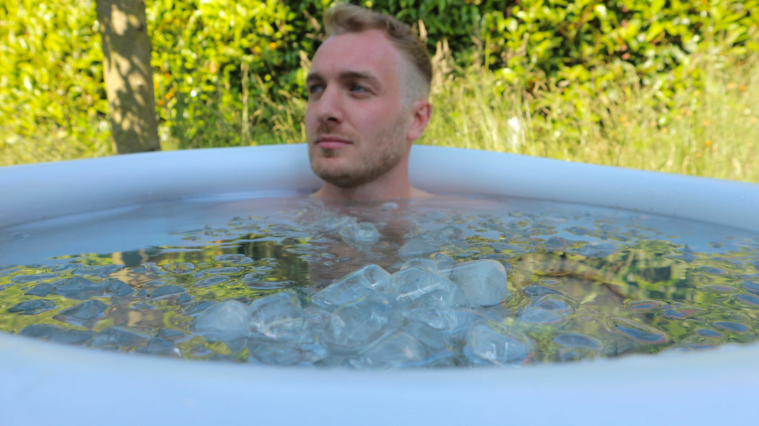 man sitting in ice bath with ice on hot day